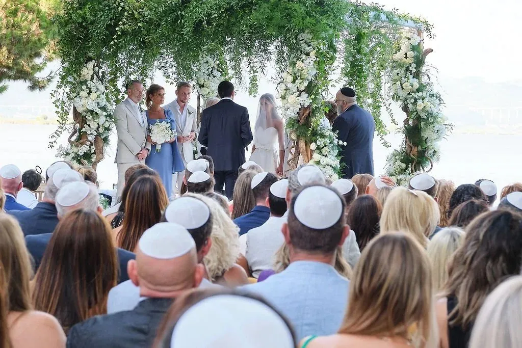 Jewish wedding chuppah ceremony with guests seated facing the chuppah